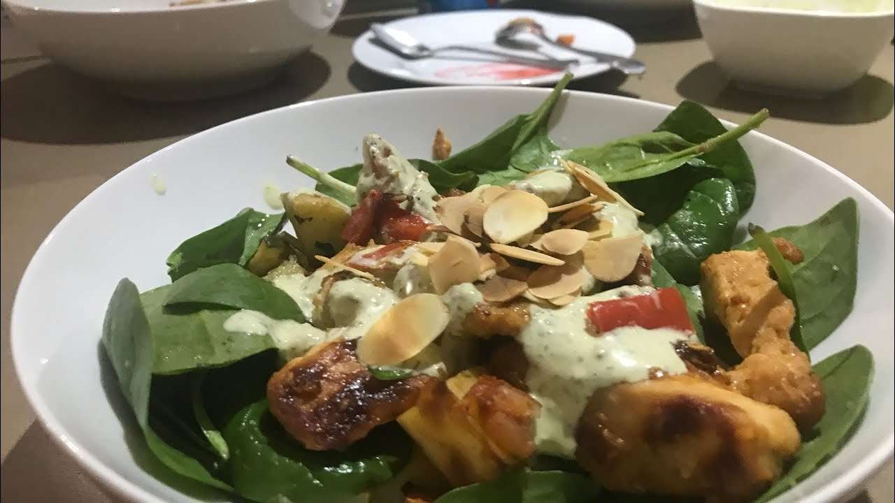 Smoked paprika chicken and vegetable tray bake with a creamy pesto dressing and roasted almonds.