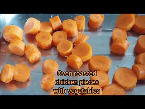 Oven roasted spicy chicken pieces with carrots and potatoes, hot madras Indian spices chilli paprika