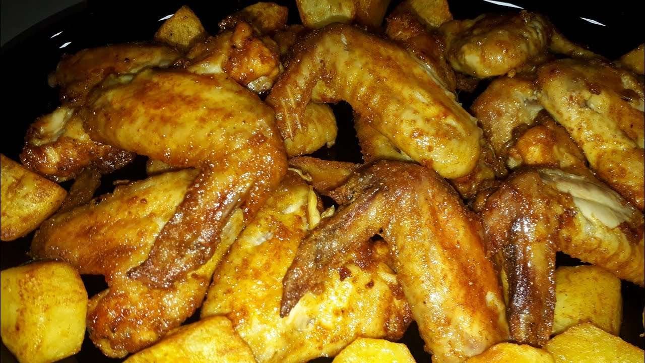 bake chicken wings with sweet paprika and bake potato on the side